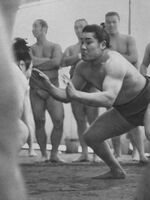 Saganoumi launches at his opponent during a training session