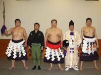 Takuro serves as yobidashi for Kitanoumi's kanreki dohyo-iri (c. 2013)