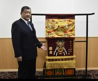 Ochiai presented with his kesho-mawashi (c. 2023)