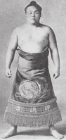 Tsukubane poses with his kesho-mawashi