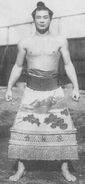 Tsunenoyama poses with his kesho-mawashi