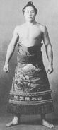 Surugaumi poses with his kesho-mawashi