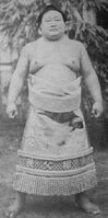 Wakachichibu poses with his kesho-mawashi (c. 1967)