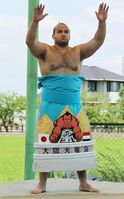 Osunaarashi presents his new kesho-mawashi (c. 2013)