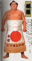 Tochimatoi poses with his kesho-mawashi (c. 1986)