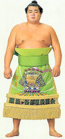 Yoshinobori poses with his kesho-mawashi (c. 1992)