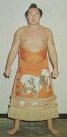 Shiratayama poses with his kesho-mawashi (c. 1976)
