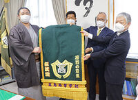 Tochimusashi presented with his kesho-mawashi (c. 2022)