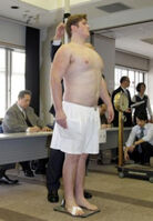 Homarenishiki gets measured upon joining professional sumo (c. 2015)
