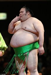  in his bright green silk  - reserved only for rikishi of  status