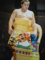 Kumao during the Juryo dohyo-iri (c. 1990)