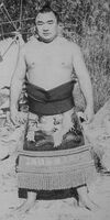 Tsurugamine poses with his kesho-mawashi (c. 1967)