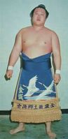 Kaneshiro poses with his kesho-mawashi (c. 1976)