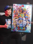 Luke Lerdwichagul holding the purchased version of the poster, with Mario's full skeleton in the poster.