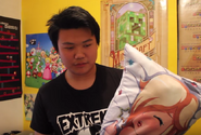 Luke holding a pillow with Rosalina on it.