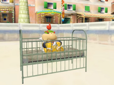 Bowser Jr. sitting in an old crib.