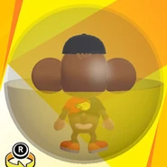 AiAi wearing a black banana cap, a black and red bi-color banana shirt, red low-cut low-tech sneakers, and in a yellow ball (back view)