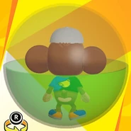 AiAi wearing a white banana cap, a black and blue bi-color banana shirt, blue low-cut low-tech sneakers, and in a green ball (back view)