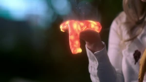 Lilith melts the Equalizer in the palm of her hand.