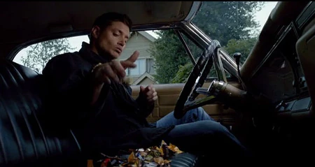 Dean indulges in Halloween candy while staking out the Wallace residence.