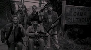 Bobby, Castiel and three other hunters have their photo taken.