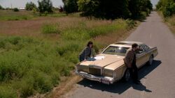 Castiel and Hannah are on the side of the road and trying to read a map