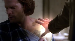 Castiel probing Sam's wound