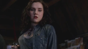 Meg holding her bloody Angel Blade after killing Hester