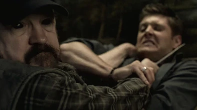 Bobby struggles with the demon that's trying to kill Dean.
