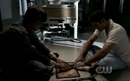 Sam using a spirit board to communicate with Dean during the latter's near-death state.