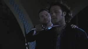 An Angel holds Sam at Knife point