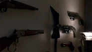 Dean's weapons on his bedroom wall.