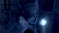 Sam holds back a hellhound.