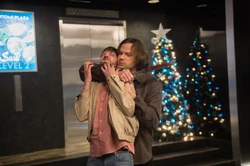 Sam subdues Garth while the latter is under Alternate Michael's control