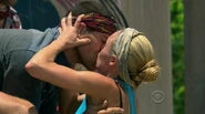 Candice wins the duel and kisses her husband John.