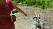 Sandra throws Russell's hat in the fire.