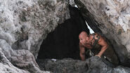 Tony hides in a rock cave.