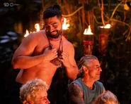 Feras pulling out his idol at Tribal Council.