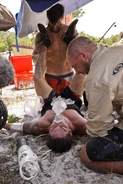Nick assists in the medical team's efforts to lower Caleb's temperature.