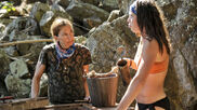 Debbie conversing with Sarah at the water well.