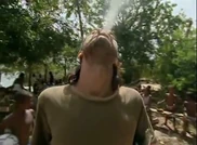 Shane smokes a cigarette.