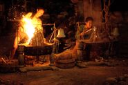 Becky and Sundra competing in a fire-making tiebreaker.