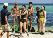 Jeff hands Vati the Immunity Idol.