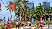 Fenella and Heath hold sacks for the Contenders tribe at the tenth Immunity Challenge.