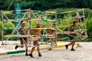 The Merged Tribe competing in the Reward Challenge, Cage Against the Machine.