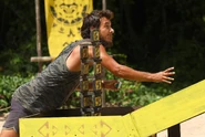 The Merged Tribe competing in the Immunity Challenge, House of Cards.