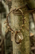 Samoa A necklace of artifacts and a hei matau hook.