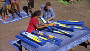 Sandra and Jeff solving the puzzle for Nuku in Austin's Elemental Obstacle Course.