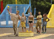 Cole tossing sandbags for Soko in Block in a Hard Place.