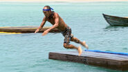 Tai leaps into the water during the final six Reward Challenge.